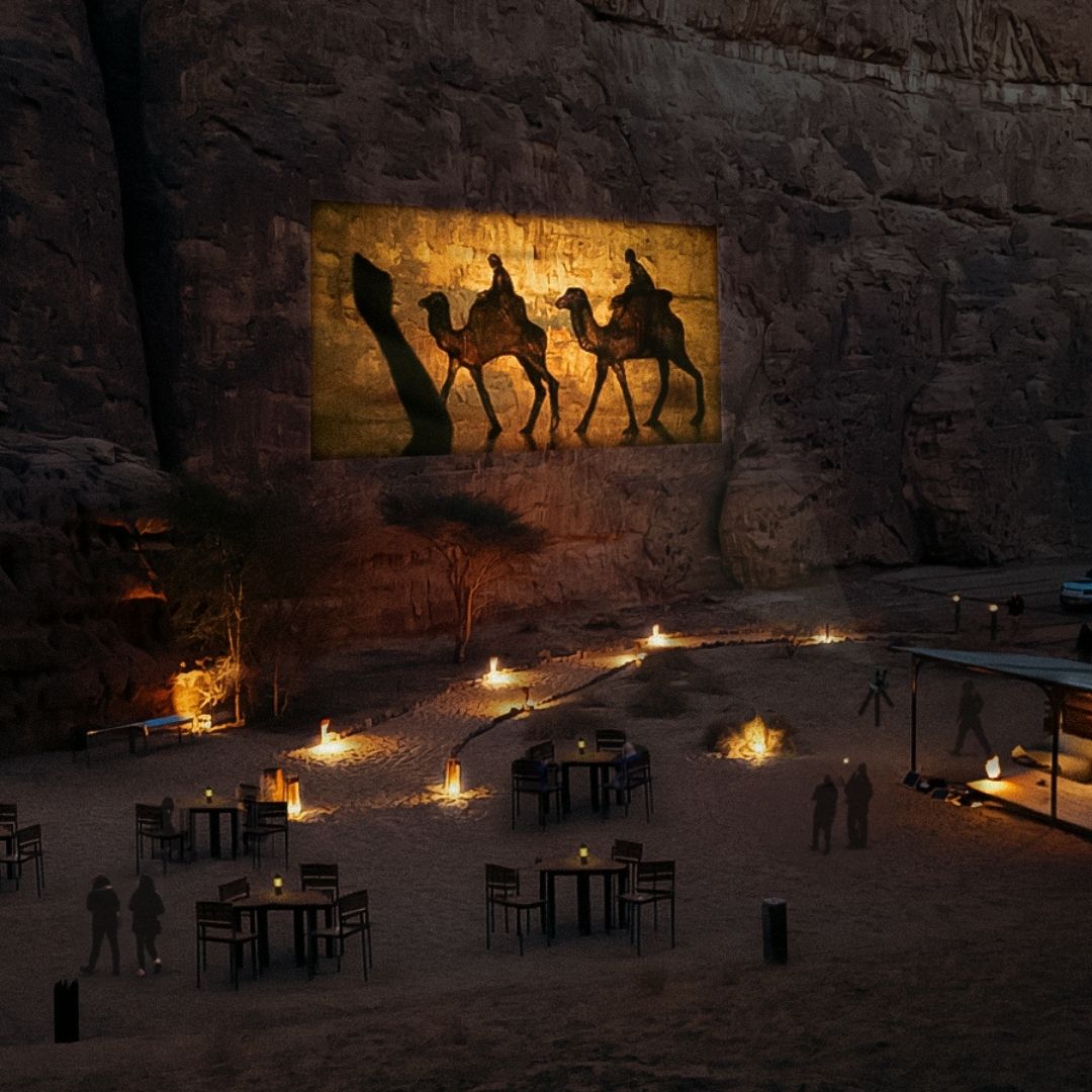 Watch a projection of sand art on the canyons